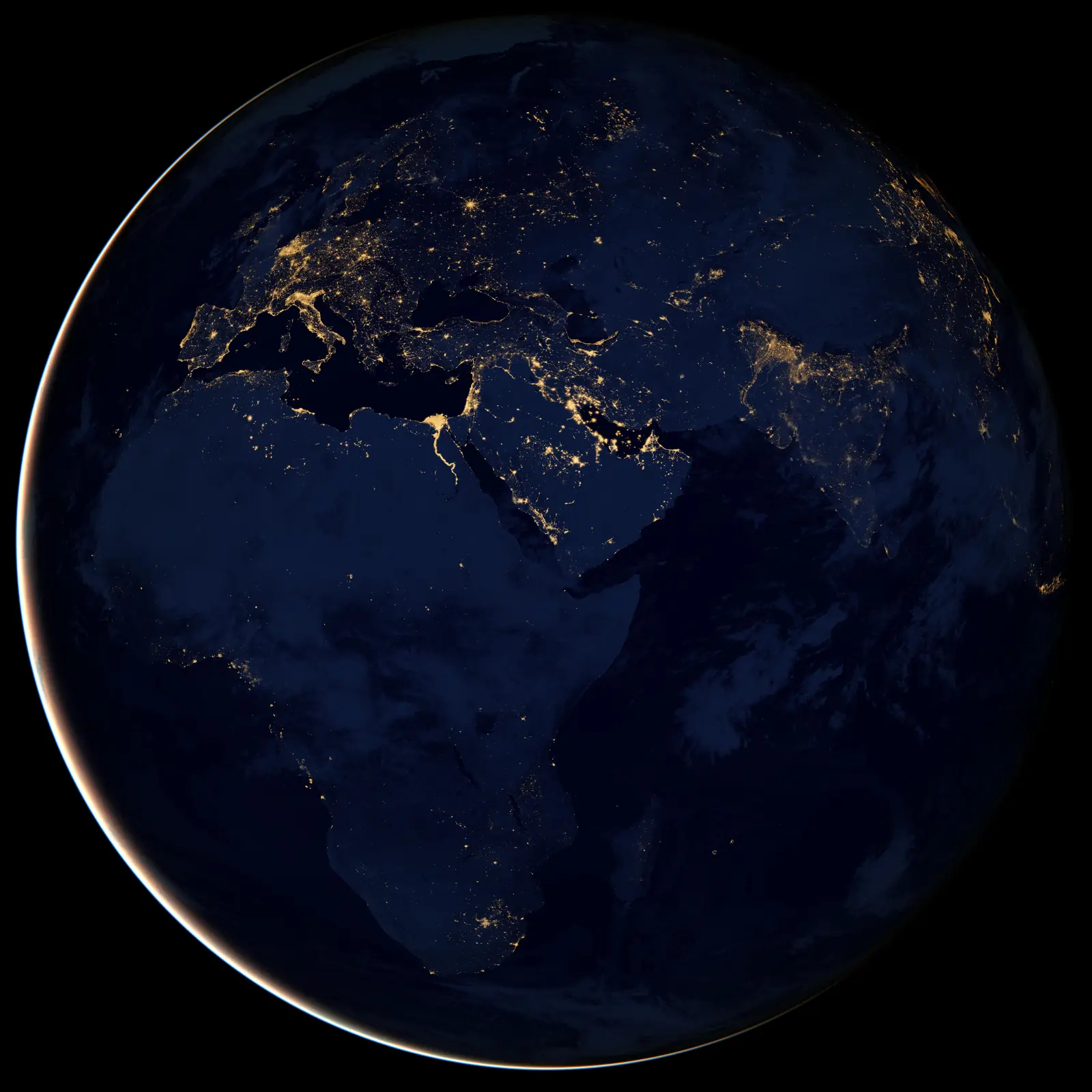 Full Earth globe seen at night against black space, with the city lights of Africa, Europe and the Middle East